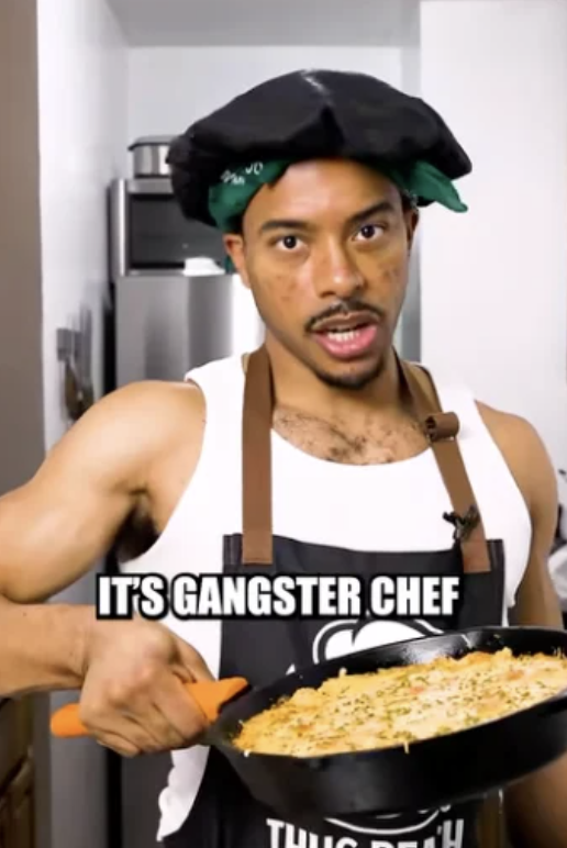 Jourdain Fisher as Gangsta Chef holding a finished skillet dish